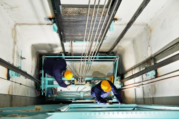 people working in elevator
