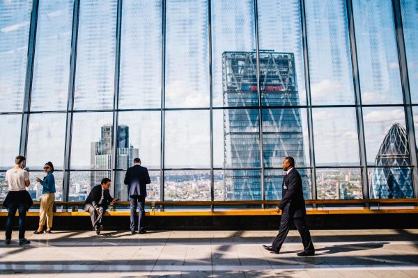 person in suit walking in building